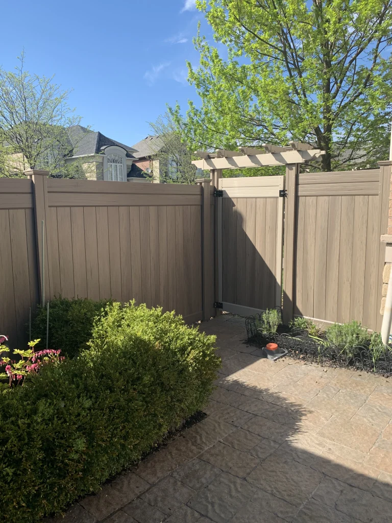 Minimalist beige vinyl gate installation for a residential property in Oshawa, featuring clean lines and a modern aesthetic.