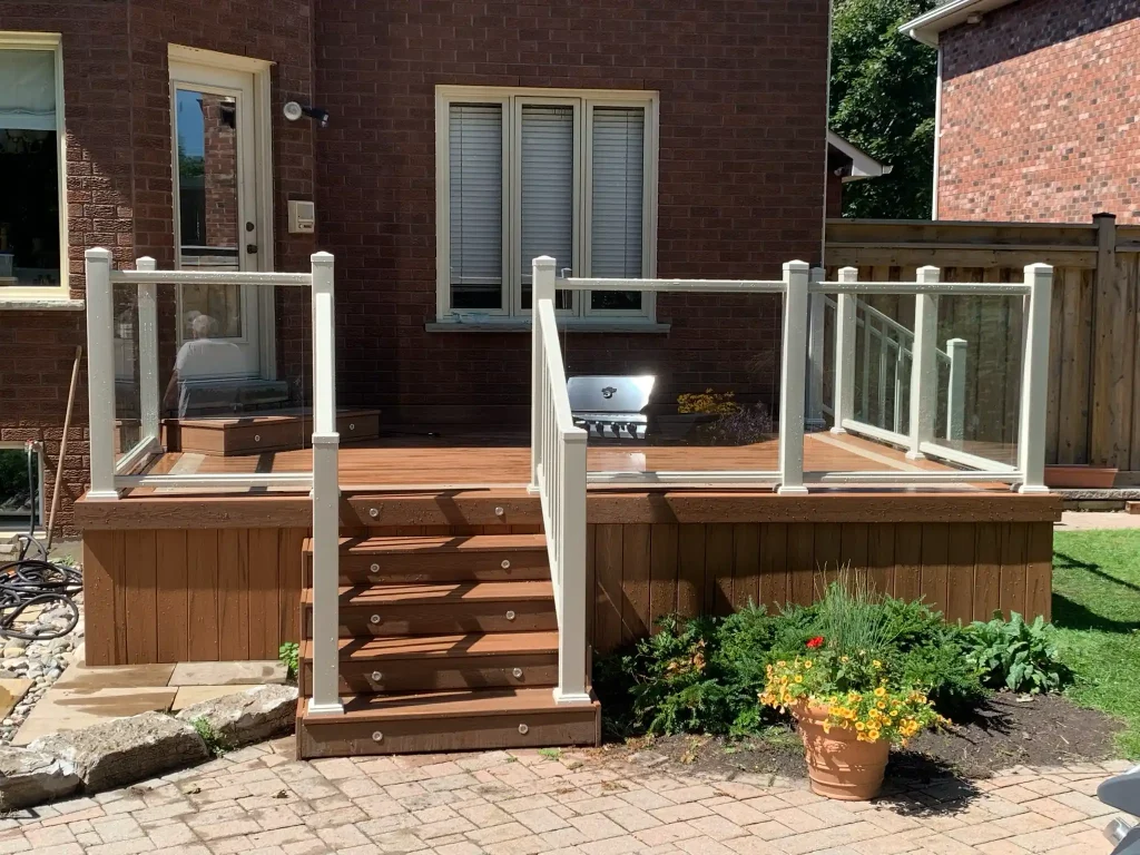 Beige glass deck railing system installed on a residential property in Ontario