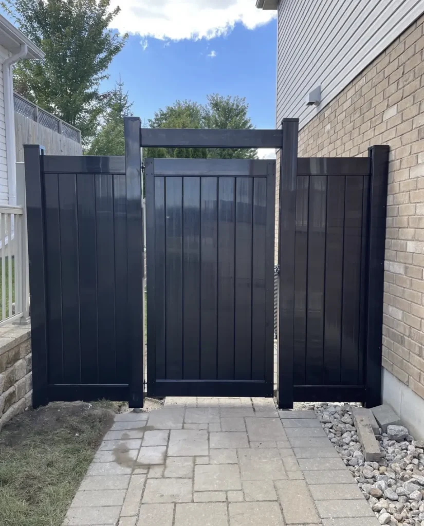 Custom black aluminum gate installation for a residential property in Peterborough, Ontario.