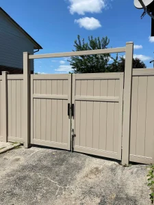Light grey vinyl gate allowing for airflow while maintaining total privacy for a side yard.