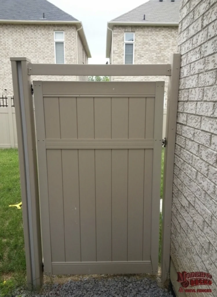 Beige vinyl privacy gate installed between two homes for a residential property in Whitby.