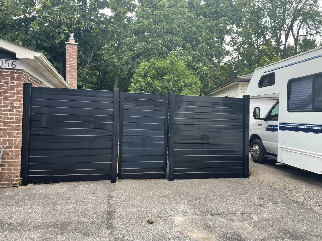 Large-panel black aluminum gate installation for a residential property in Peterborough, Ontario.