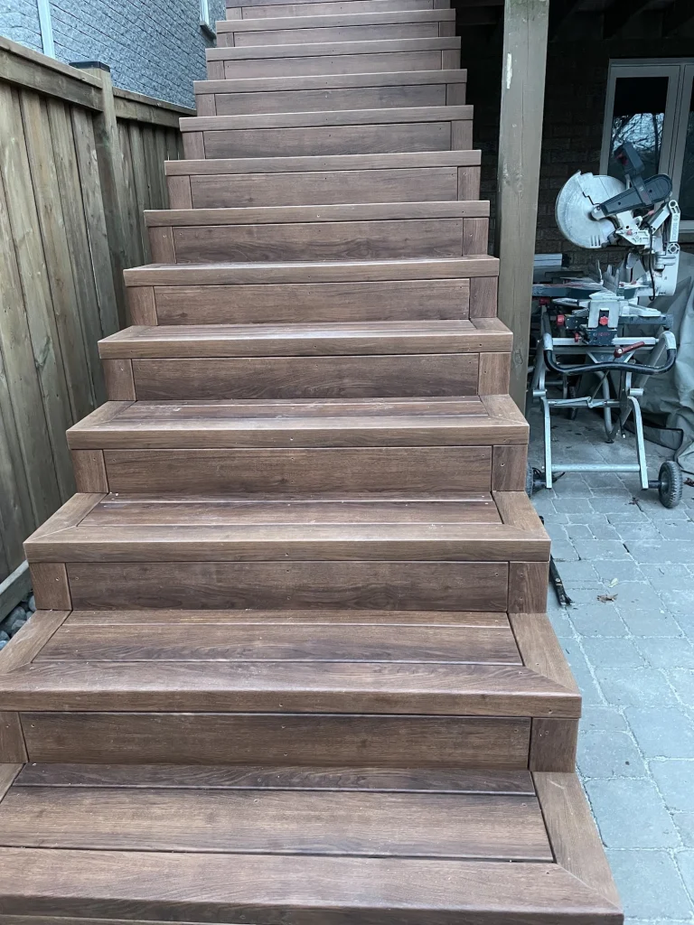 Close-up of durable brown composite deck stairs professionally installed for a Bowmanville residence.