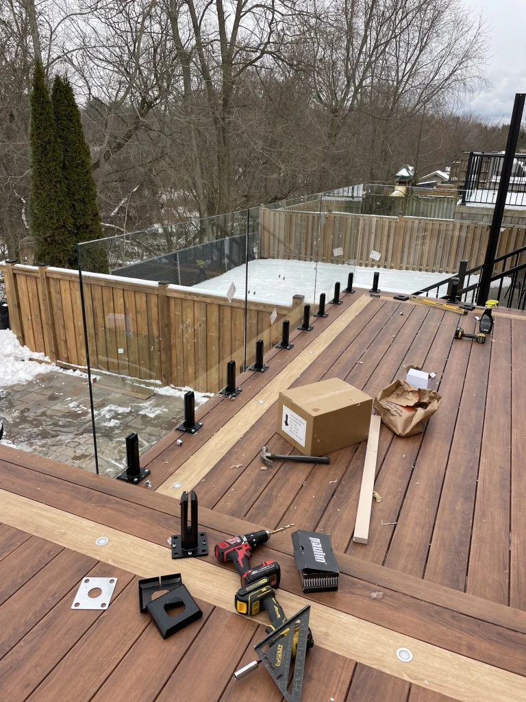 Professional deck construction in progress in Bowmanville, showing the high-quality structural framing and joist work.