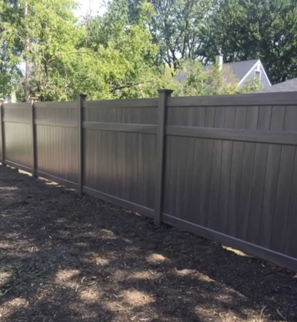Modern black vinyl privacy fence providing a sleek and contemporary look for a home in Bowmanville.