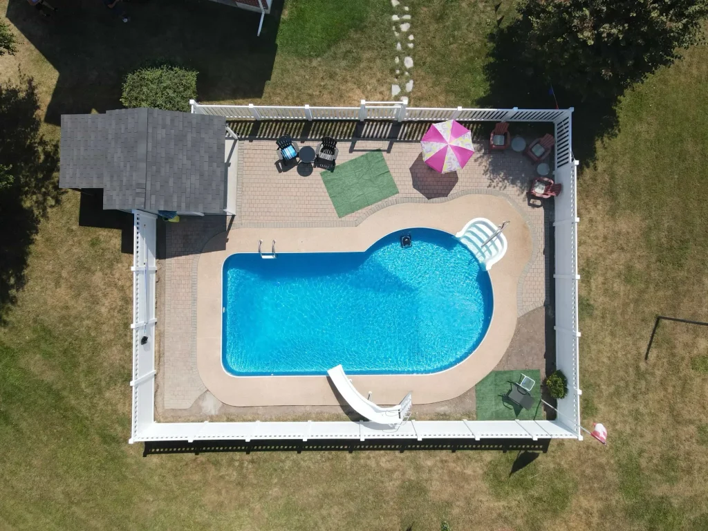 Aerial drone photography of a completed full-perimeter vinyl fence installation project across a large Bowmanville property.