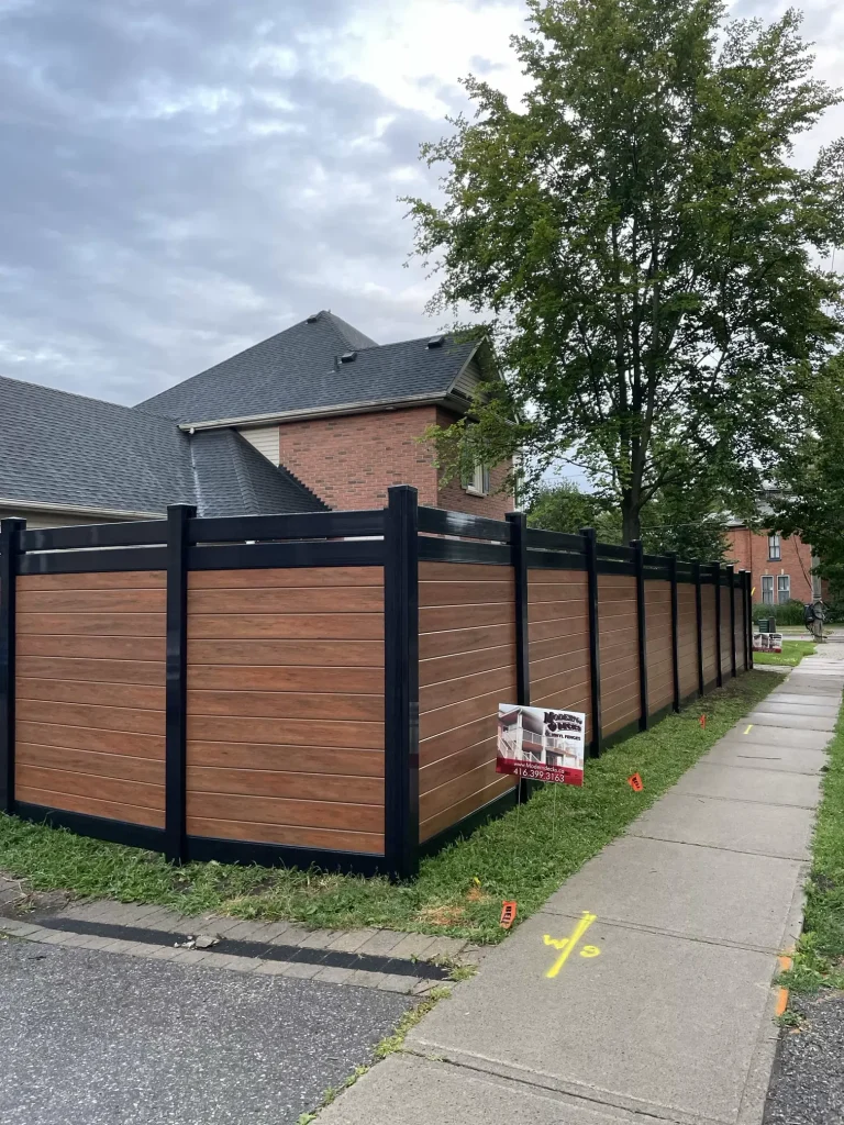 Premium lava-coloured vinyl fencing in Bowmanville, showcasing a rich, dark earth-tone finish for enhanced curb appeal.