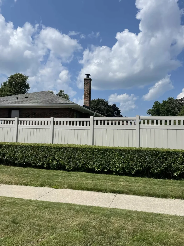Modern light grey vinyl fence installation in a Bowmanville backyard, providing a clean and contemporary landscape border.