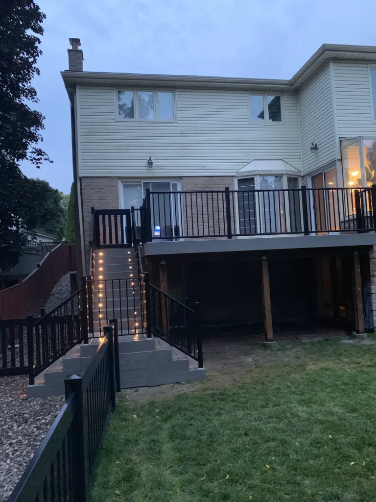 Wide-angle view of a custom deck with black aluminum railings in Pickering.