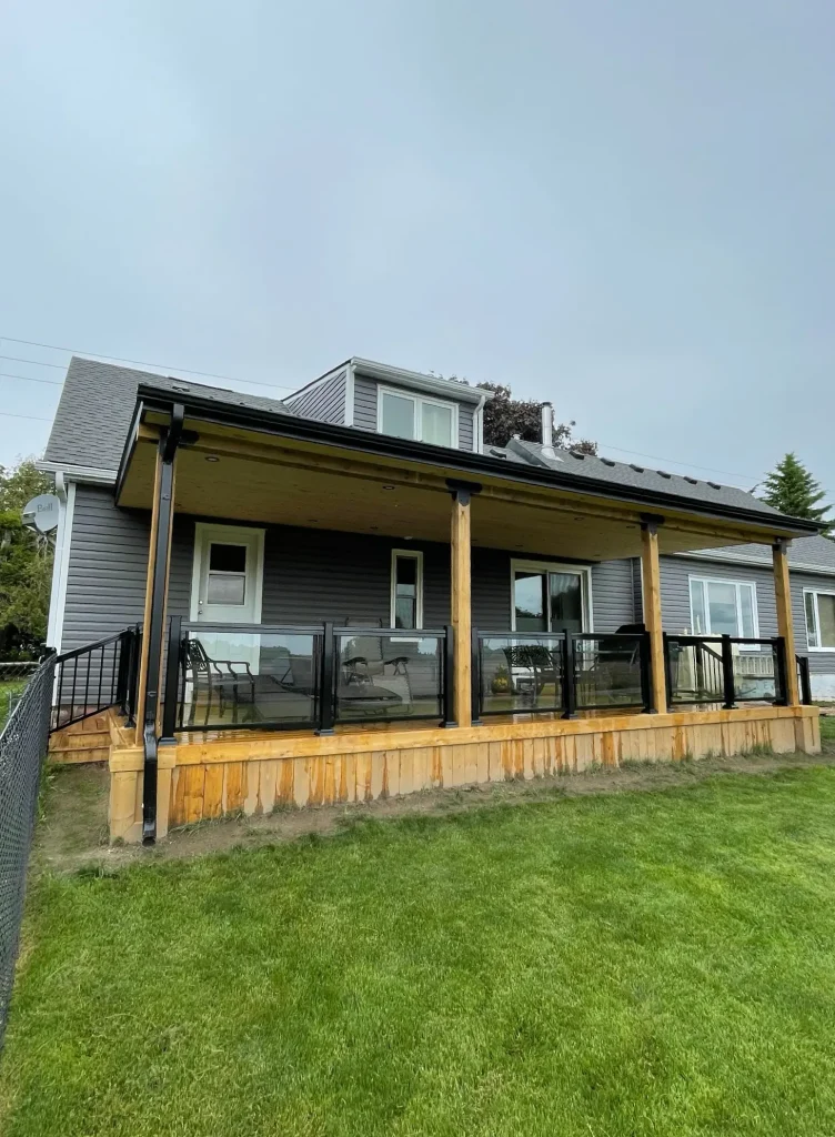 Custom raised deck in Bowmanville featuring modern black metal spindles and new deck construction.