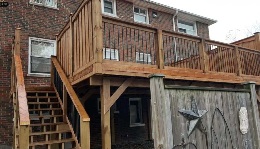 Elevated pressure-treated wood deck construction featuring a sturdy support structure in Oshawa.