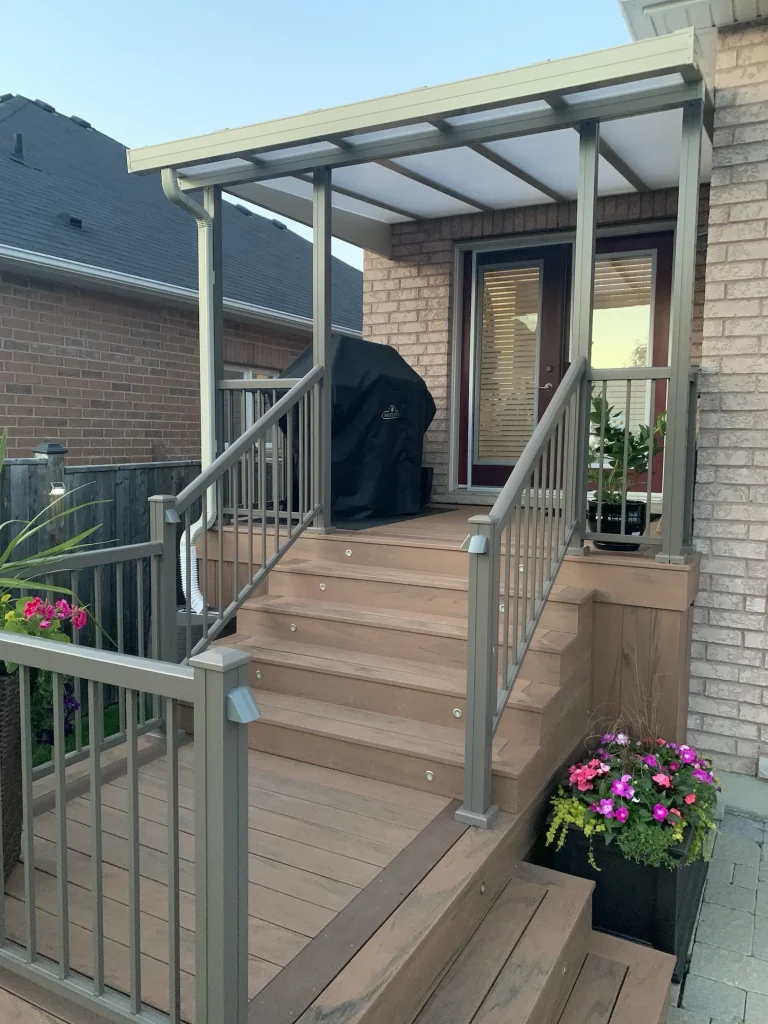 Custom TruNorth composite deck in Ipe colour, offering a luxury wood-look finish for a low-maintenance backyard in Bowmanville, Ontario.