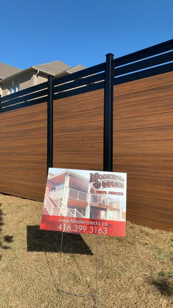Close-up detail of a vinyl woodgrain fence installation in Ontario, showcasing the realistic texture and durable finish.